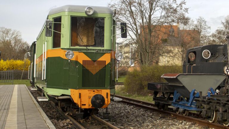 Zielono-pomarańczowy wagon na peronie stacji Maltanka